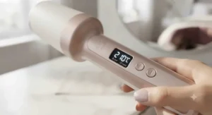 LED digital temperature display screen on the handle of an automatic hair curler