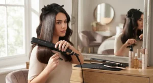 Professional-grade hair straighteners being used to create a glossy, straight hairstyle for a salon-quality look at home.