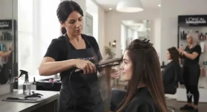 A stylist using high-performance hair straighteners under £50 to create a sleek look.