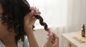 Hands gently unbending and sliding out a flexi rod to reveal a shiny, smooth curl