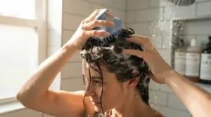 A scalp scraper for buildup being applied during a deep cleansing hair wash day