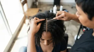 Using a tail comb for sectioning hair accurately to create clean vertical plaits